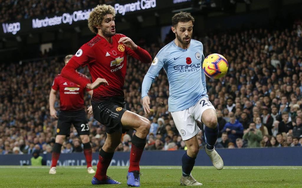Bernardo Silva of Manchester City chased by Marouane Fellaini of Manchester United ManU during the Premier League match at the Etihad Stadium,