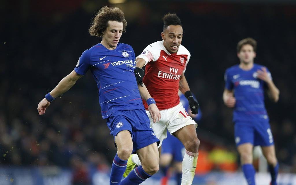 Chelsea s David Luiz (L) is challenged by Arsenal s Pierre-Emerick Aubameyang during the 23th round English Premier League match between Arsenal and Chelsea at the Emirates Stadium in London