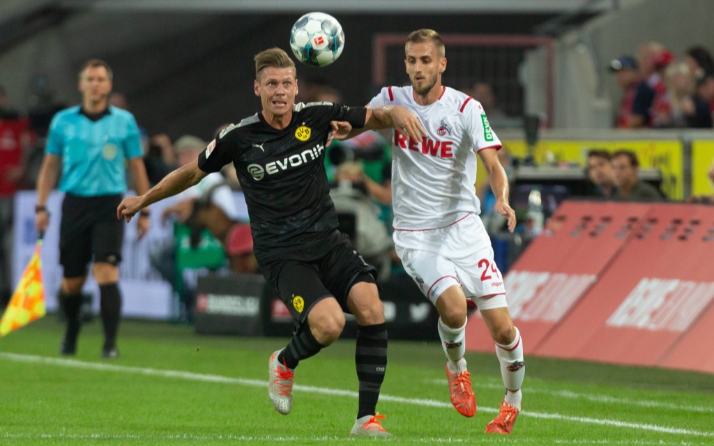 Koeln, Deutschland, 23.08.2019, 1. Bundesliga 2. Spieltag, 1. FC Koeln - Borussia Dortmund, Lukasz Piszczek (Dortmund, L) und Dominick Drexler (Koeln).