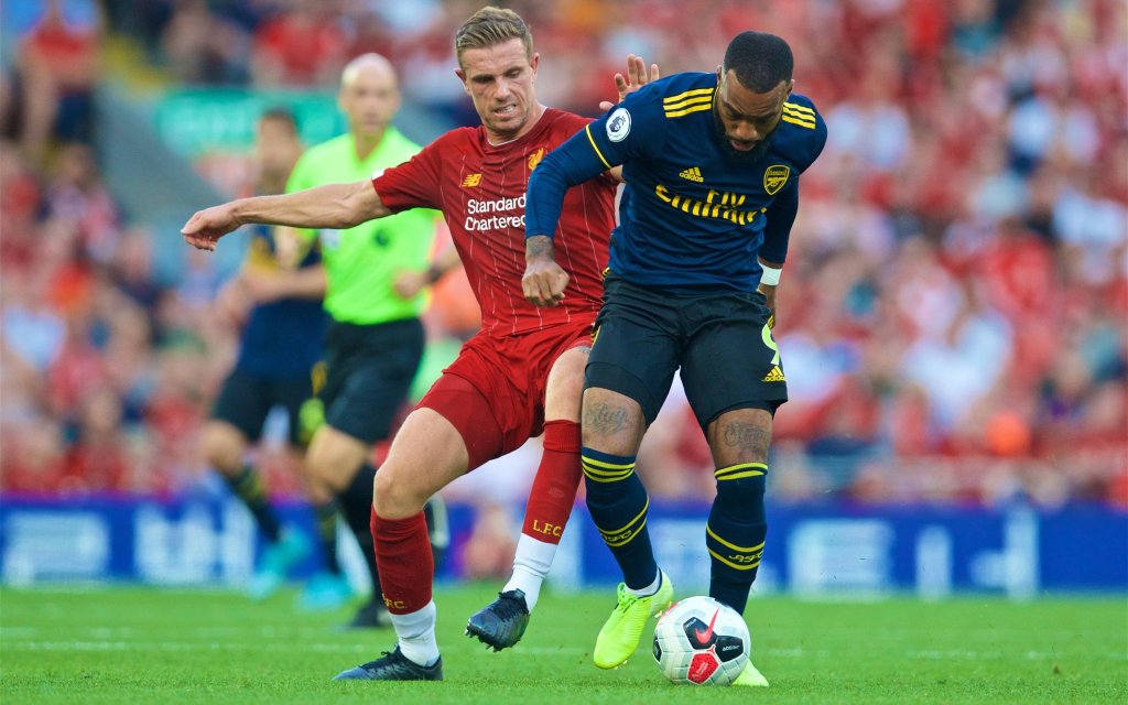 (190825) -- LIVERPOOL, Aug. 25, 2019 -- Liverpool s captain Jordan Henderson (L) challenges Arsenal s Alexandre Lacazette during the English Premier League match between Liverpool FC and Arsenal FC at Anfield in Liverpool