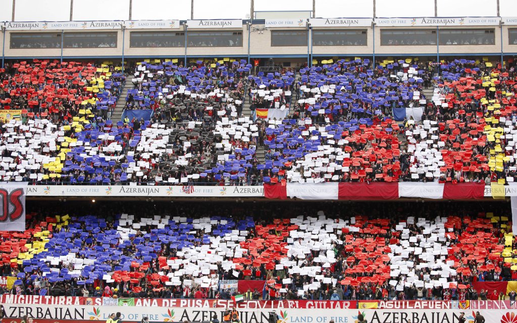Atletico de Madrid s supporters show banners with the club s flag during La Liga match in Vicente Calderon stadium in Madrid, Spain.